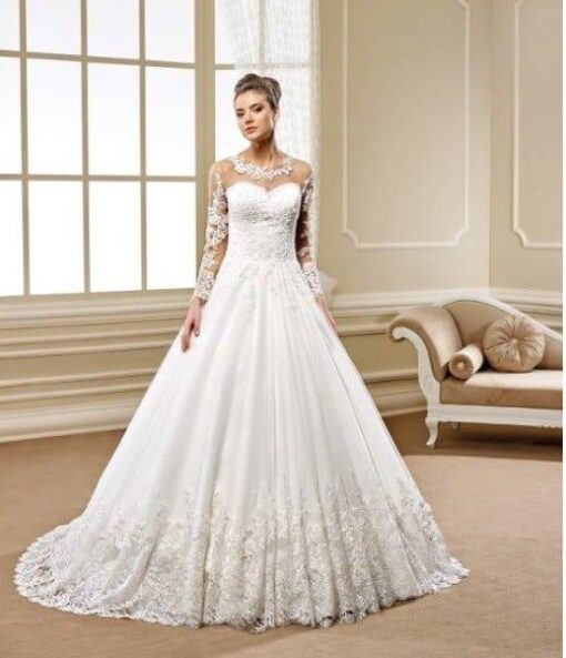 Sheer long sleeve lace wedding gown with ball gown skirt