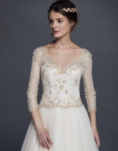 white and gold colored wedding gowns with long sleeves