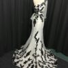 back of white & black evening dresses by Darius Cordell