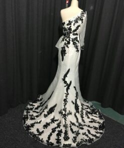 back of white & black evening dresses by Darius Cordell