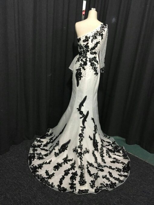 back of white & black evening dresses by Darius Cordell