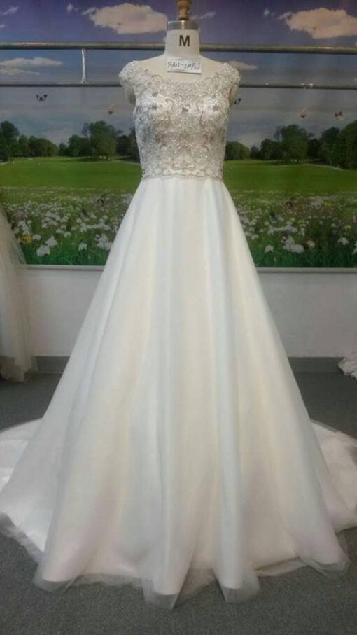 Style#FA IMPA linebeadedbridalgownwithacapsleevefromDariusCordellCoutureFashionDesigns