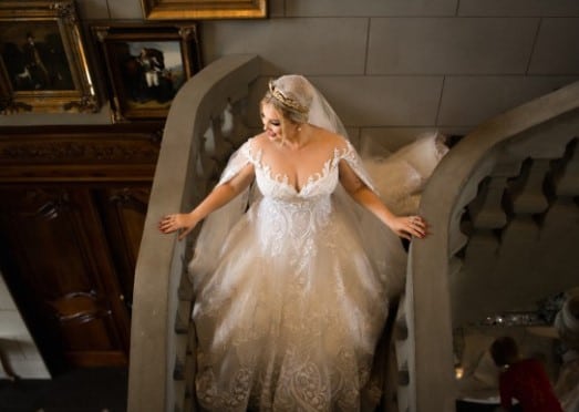 Off the shoulder plus size wedding gown with cape from Darius Couture