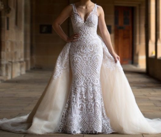 Sleeveless wedding gown with embroidery and overskirt from Darius Bridal